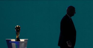 FIFA President Gianni Infantino is silhouetted as he walks past the World Cup trophy after addressing the 76th FIFA Congress, Vancouver, U.S., April 30, 2026. (AP Photo)