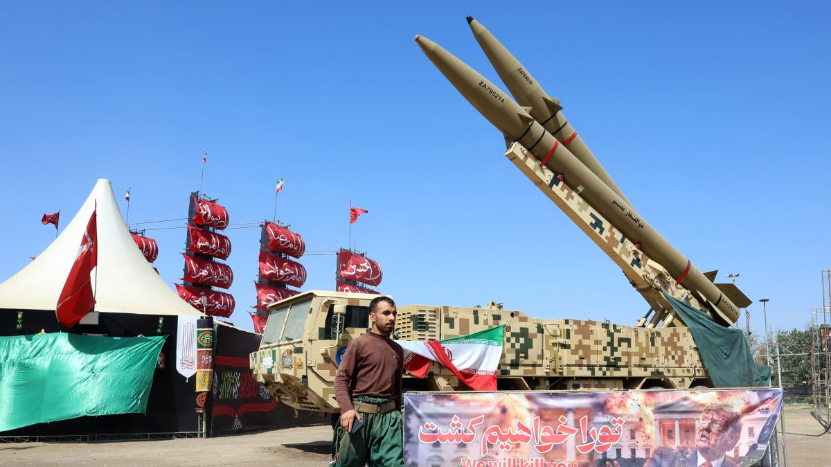 An Iranian worker walks next to the Iranian missiles 'Zolfaghar' on display at the Azadi square in Tehran, Iran, 30 July 2026. (EPA Photo)