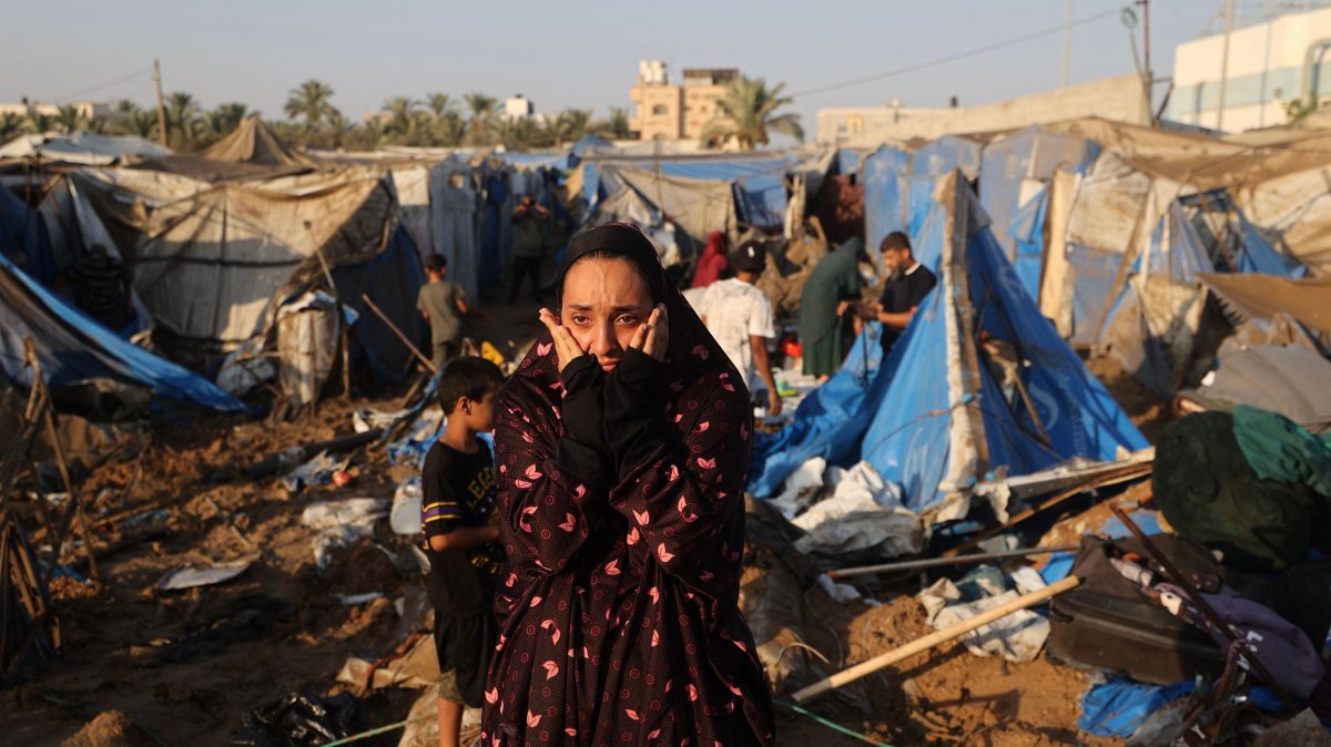 A displaced Palestinian woman reacts as she looks at the destruction of tent shelters following an Israeli airstrike in Deir el-Balah, central Gaza Strip, Palestine, Aug. 1, 2026. (AFP Photo)
