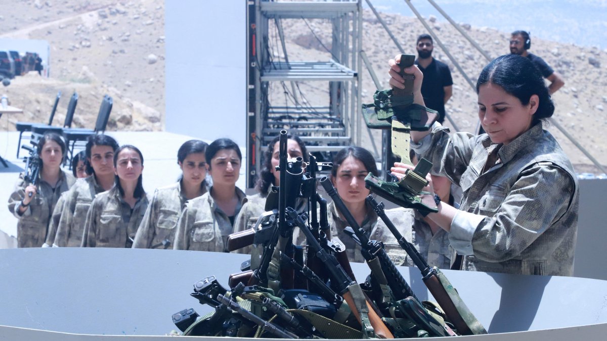 PKK members line up to put their weapons into a pit during a disarmament ceremony in Sulaimaniyah, northern Iraq, July 11, 2025. (AFP Photo)