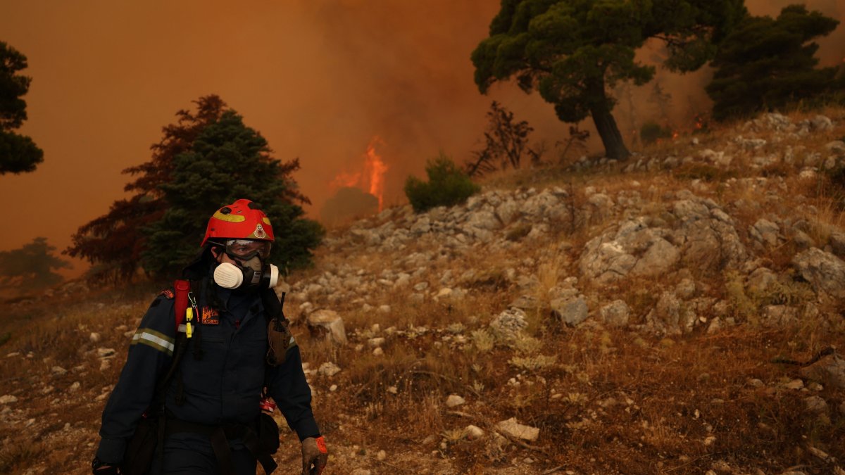 A firefighter works as a wildfire burns on Mount Kithairon, Greece, Aug. 3, 2026. (Reuters Photo)