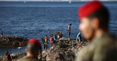 Members of the Spanish army watch a group of migrants near the border post of Spain's northern African enclave of Ceuta, Spain, Aug. 2, 2026. (AFP Photo)