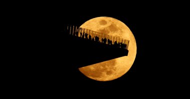 The Worm Moon rises behind the Edge outdoor observation deck at Hudson Yards, ahead of a total lunar eclipse, New Jersey, U.S., March 2, 2026. (Getty Images Photo)