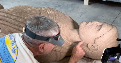 An expert works on a monumental marble statue of a young man dating back about 2,500 years, Manisa, Türkiye, Aug. 3, 2026. (AA Photo)