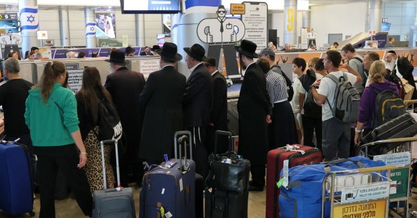 Travellers wait for their luggage at the belt upon arrival at Israel's central Ben Gurion Airport, June 25, 2025. (AFP Photo)