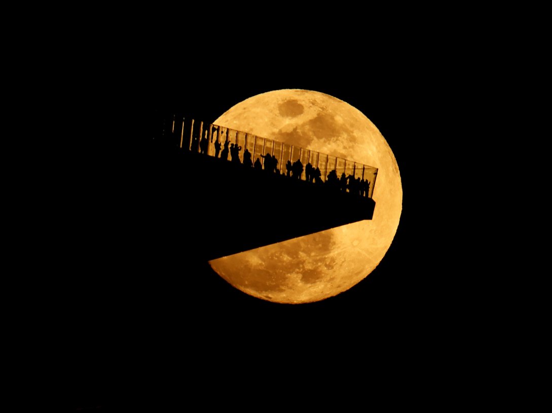 The Worm Moon rises behind the Edge outdoor observation deck at Hudson Yards, ahead of a total lunar eclipse, New Jersey, U.S., March 2, 2026. (Getty Images Photo)