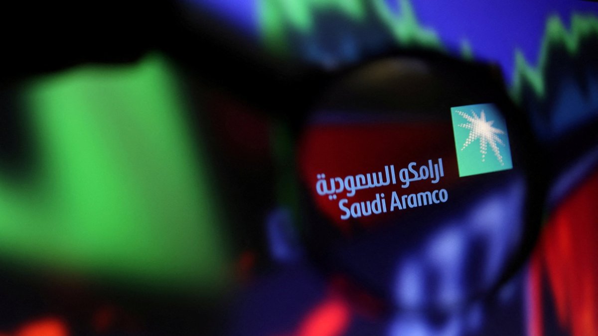 The Saudi Aramco logo and stock graph are seen through a magnifier displayed in this illustration taken on Sept. 4, 2022. (Reuters Photo)