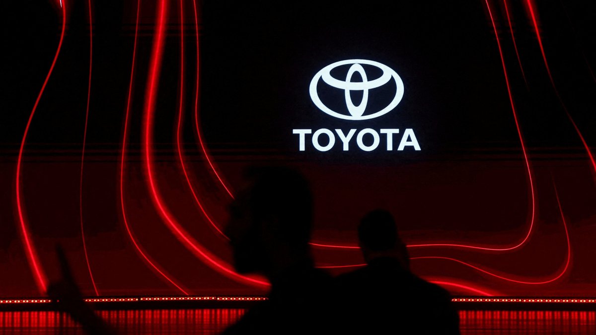 A man walks past the Toyota logo during a launch event, Mumbai, India, Jan. 20, 2026. (Reuters Photo)