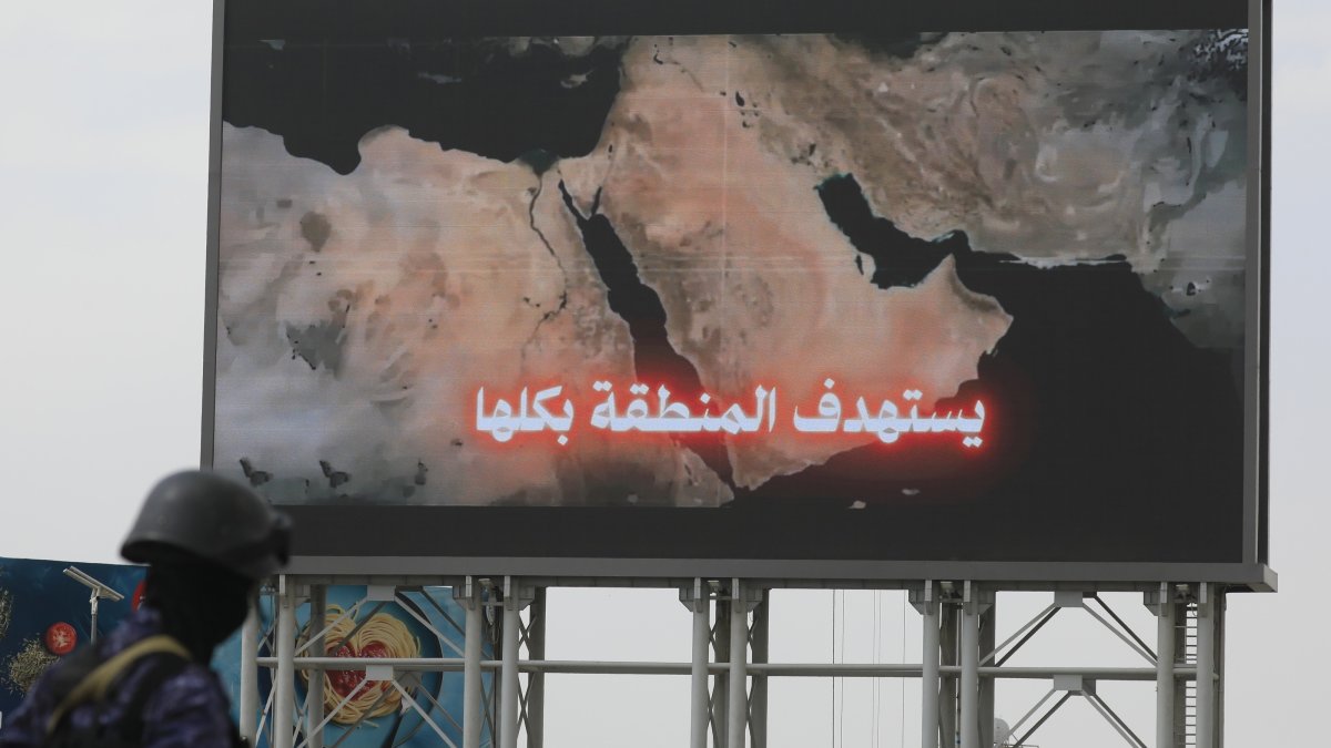 A Houthi soldier (L) stands guard in front of a map of the Middle East region on a billboard during a protest against Saudi Arabia, Sanaa, Yemen, July 31, 2026. (EPA Photo)