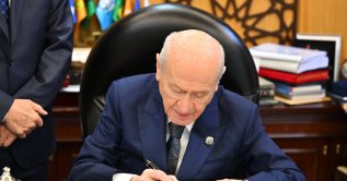 MHP leader Devlet Bahçeli, who first championed terror-free Türkiye, signs the draft bill, Ankara, Türkiye, Aug. 4, 2026. (AA Photo)