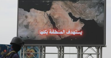 A Houthi soldier (L) stands guard in front of a map of the Middle East region on a billboard during a protest against Saudi Arabia, Sanaa, Yemen, July 31, 2026. (EPA Photo)