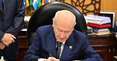 MHP leader Devlet Bahçeli, who first championed terror-free Türkiye, signs the draft bill, Ankara, Türkiye, Aug. 4, 2026. (AA Photo)