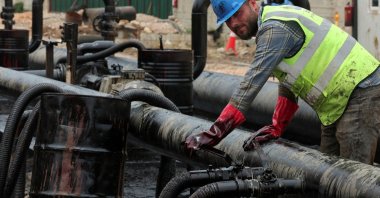 A man works during the unloading of oil from trucks arriving from Iraq at the Baniyas oil terminal, Baniyas, Syria, May 14, 2026. (Reuters Photo)