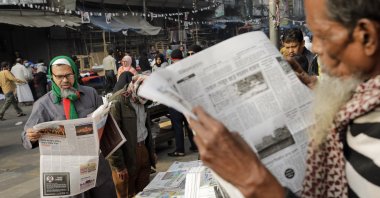 People read newspapers in the morning on the first day of the new year in Dhaka, Bangladesh, Jan. 1, 2025. (Getty Images)
