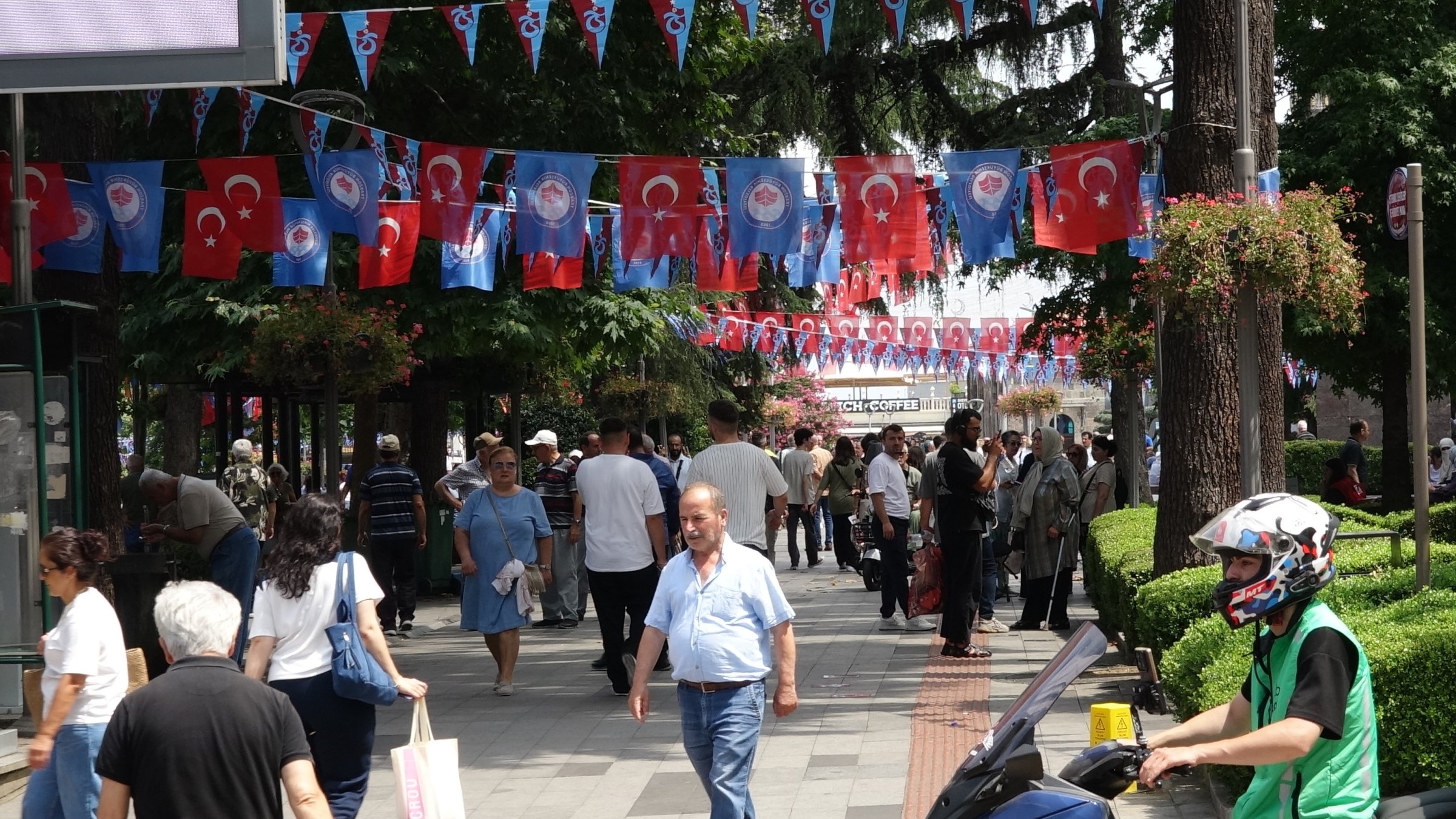 People walk on a street decorated with flags as the city awaits the arrival of Mohamed Salah, Trabzon, northeastern Türkiye, Aug. 5, 2026. (DHA Photo)