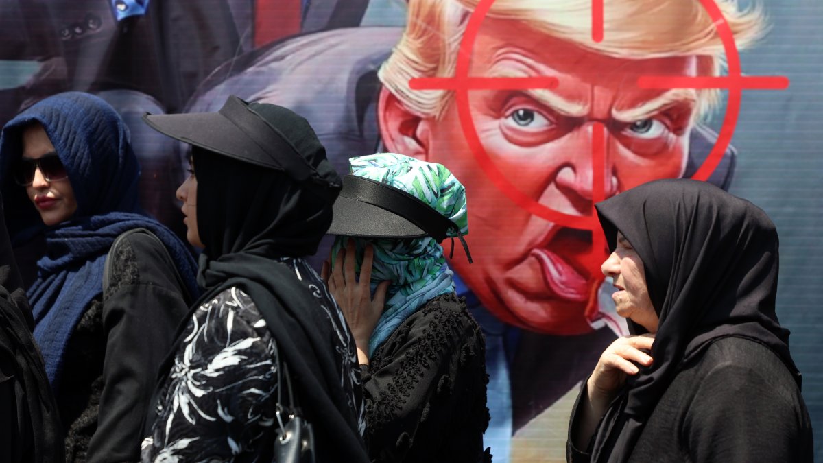 People walk past an anti-Trump banner in the streets of Tehran, Iran, Aug. 4, 2026. (EPA Photo)