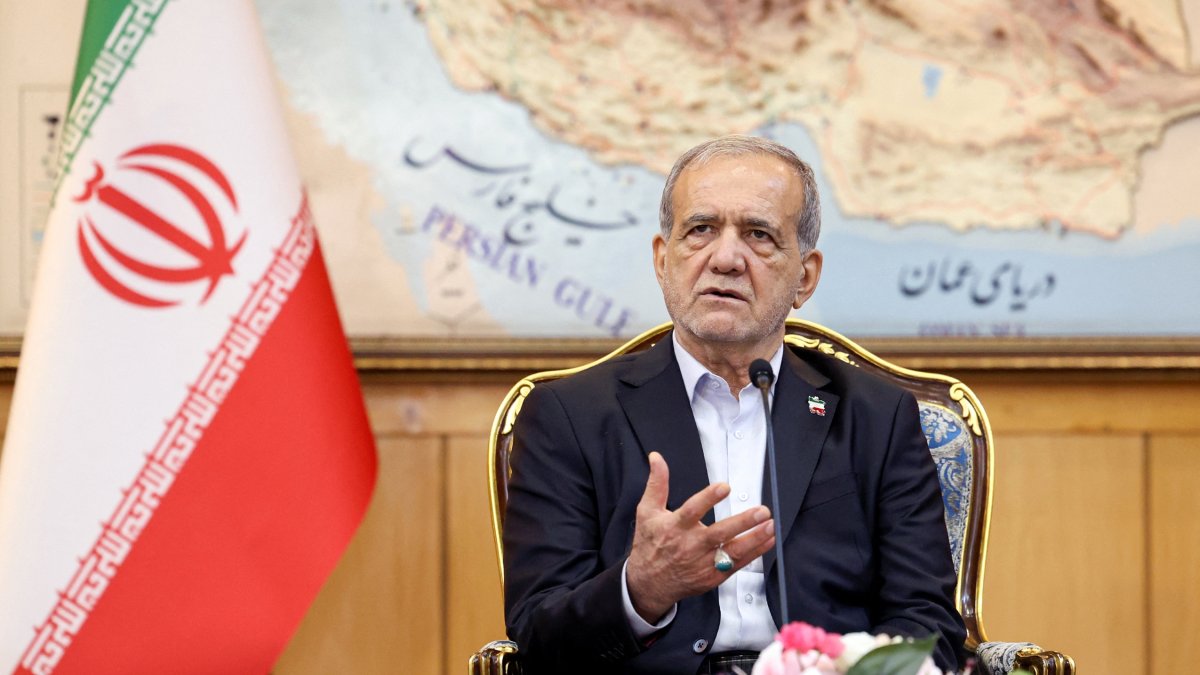 President Masoud Pezeshkian delivers a statement before boarding a plane at Tehran's Mehrabad Airport, Sept. 23, 2025. (Iranian Presidency Handout via AFP, File Photo)