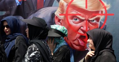 People walk past an anti-Trump banner in the streets of Tehran, Iran, Aug. 4, 2026. (EPA Photo)