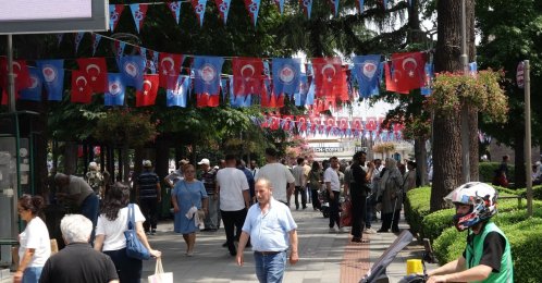 People walk on a street decorated with flags as the city awaits the arrival of Mohamed Salah, Trabzon, northeastern Türkiye, Aug. 5, 2026. (DHA Photo)