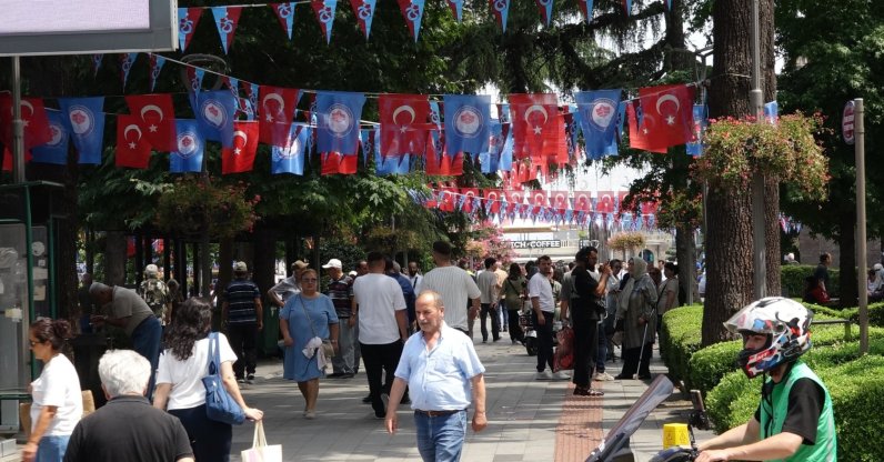 People walk on a street decorated with flags as the city awaits the arrival of Mohamed Salah, Trabzon, northeastern Türkiye, Aug. 5, 2026. (DHA Photo)