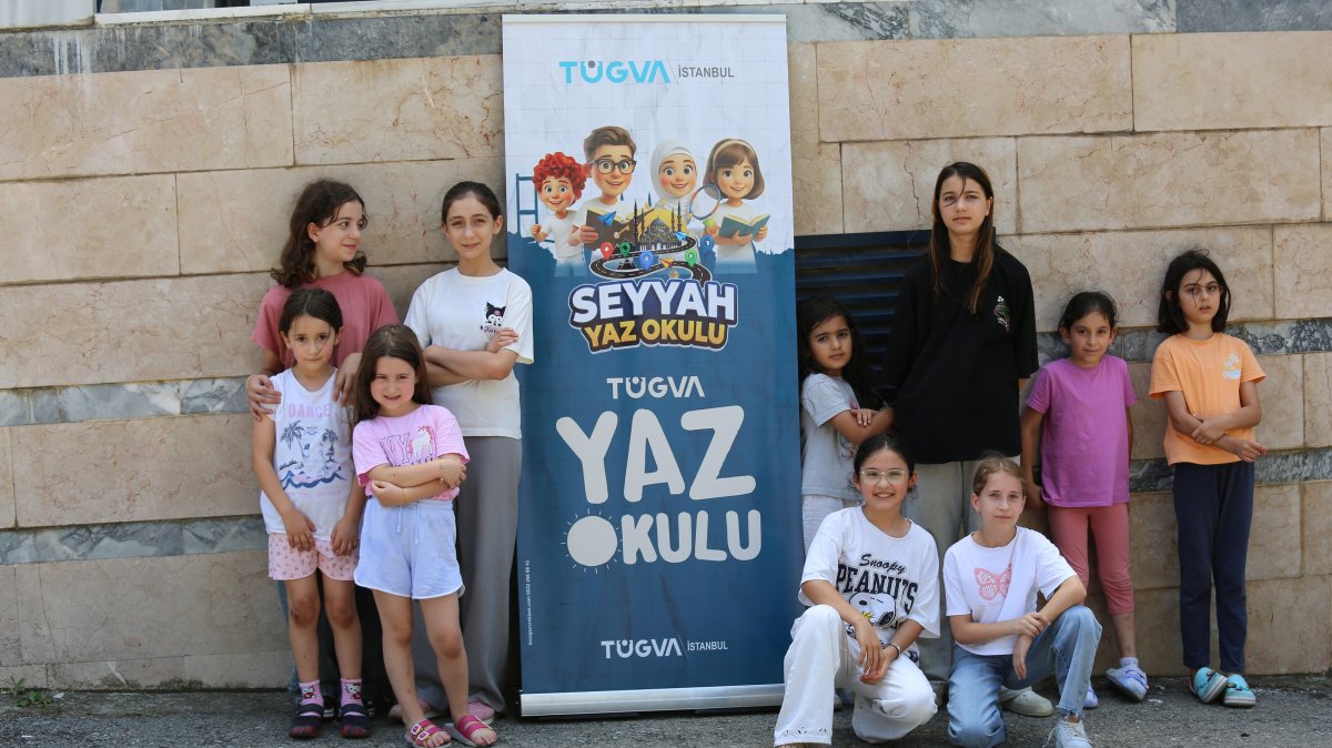 Children pose beside a TÜGVA Summer School banner during one of the Türkiye Youth Foundation's summer programs, Istanbul, Türkiye, Aug. 6, 2026. (AA Photo)