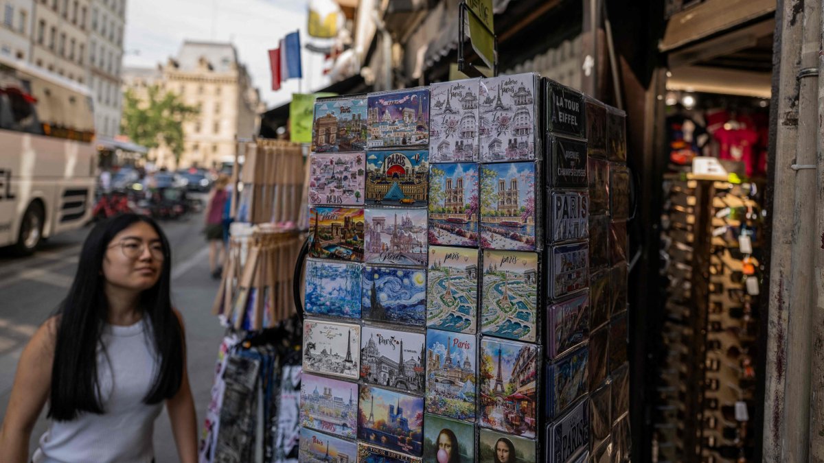 A tourist looks at goods on display at a souvenir shop in central Paris, France, July 15, 2026. (AFP Photo)