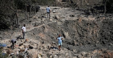 People and journalists stand at a site hit by Israeli strikes that occurred in the early hours of Thursday, in Burj al-Shamali, southern Lebanon, Aug. 6, 2026. (Reuters Photo)