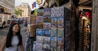 A tourist looks at goods on display at a souvenir shop in central Paris, France, July 15, 2026. (AFP Photo)