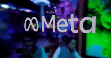 People are seen behind a logo of Meta Platforms during a conference in Mumbai, India, Sept. 20, 2023. (Reuters Photo)