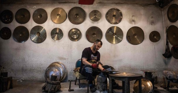 A worker hammers a cymbal at a workshop, Istanbul, Türkiye, July 30, 2026. (AFP Photo)