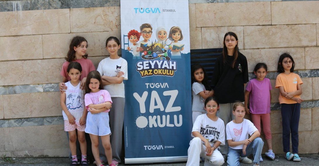 Children pose beside a TÜGVA Summer School banner during one of the Türkiye Youth Foundation's summer programs, Istanbul, Türkiye, Aug. 6, 2026. (AA Photo)