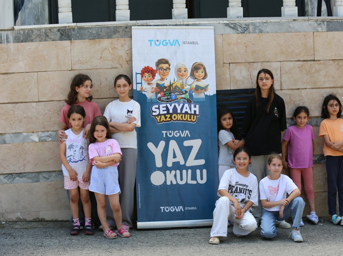 Children pose beside a TÜGVA Summer School banner during one of the Türkiye Youth Foundation's summer programs, Istanbul, Türkiye, Aug. 6, 2026. (AA Photo)