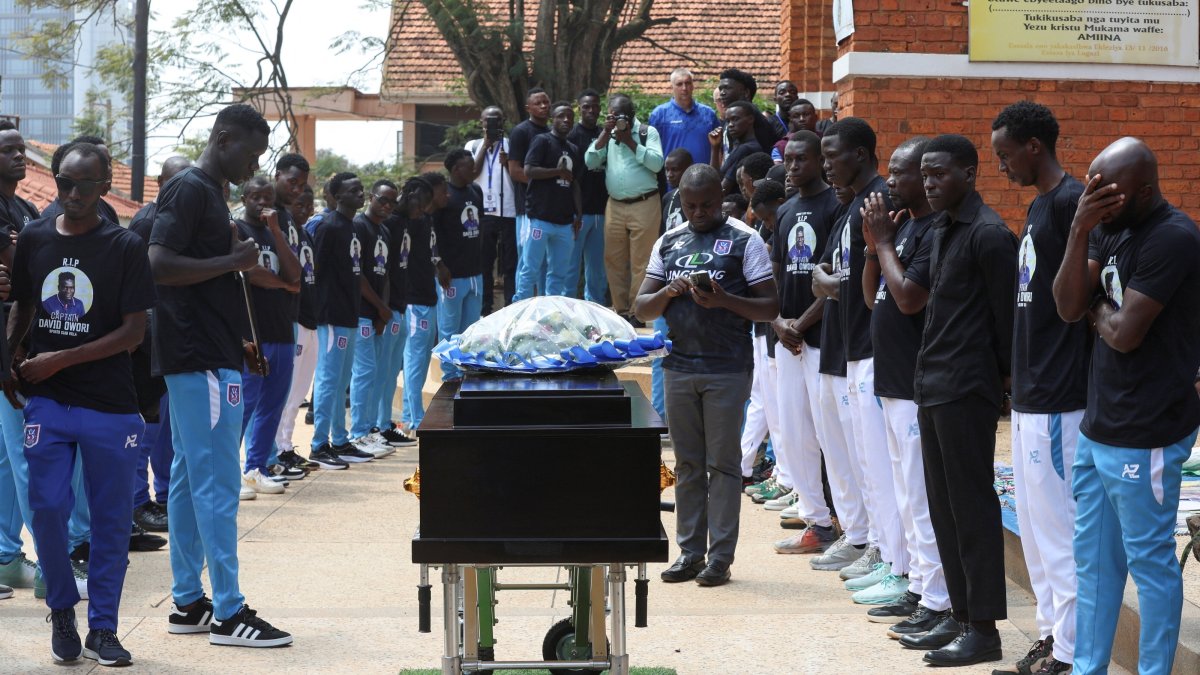 Ugandan players pay homage around the coffin before attending the requiem mass of the late David Owori, 28, a Ugandan international player and captain of SC Villa, who was critically injured by unidentified assailants and was later pronounced dead, at the St. Peter's Catholic Church Nsambya, Kampala, Uganda, Aug. 6, 2026. (Reuters Photo)