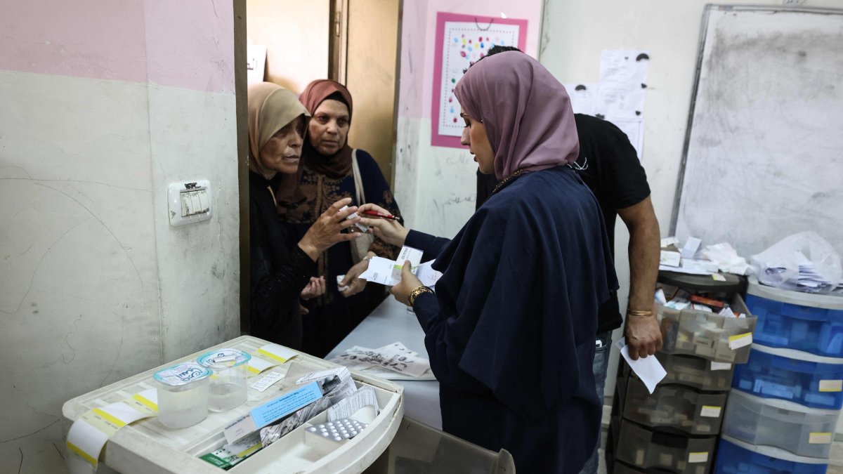 Medics distribute medication to Palestinian patients at a makeshift pharmacy set up by Israeli NGO Physicians for Human Rights-Israel (PHRI)'s mobile clinic in Iktaba, on the outskirts of Tulkarem, West Bank, Aug. 4, 2026. (AFP Photo)