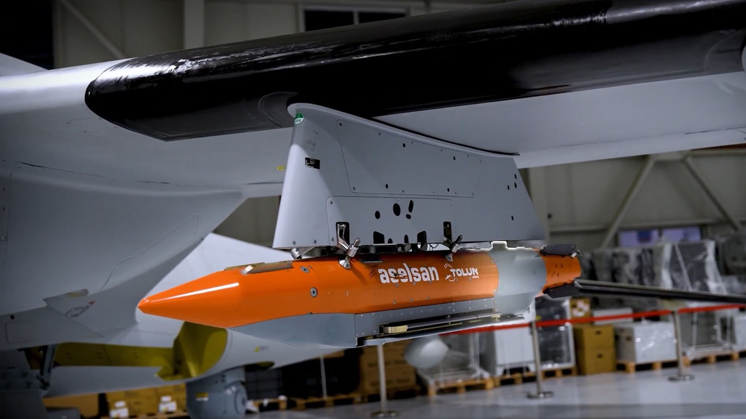 Tolun P precision-guided bunker-busting munition is seen attached to the Bayraktar Akıncı combat drone. (DHA Photo)