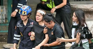 Family members of a teacher who was killed in a school shooting are led to an ambulance in Bang Kruai district, Nonthaburi province, Bangkok, Thailand, Aug. 7, 2026. (AFP Photo)