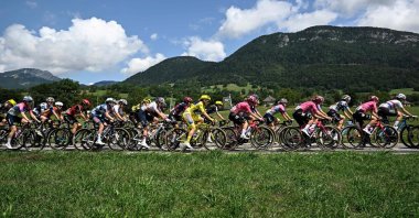AG Insurance - Soudal Team's Mauritius rider Kimberley Le Court Pienaar wearing the overall leader's yellow jersey and the pack ride during the 8th stage (out of 9) of the fourth edition of the Women's Tour de France - Tour de France Femmes cycling race, 111.9 km from Chambery to Saint-François-Longchamp, near La Motte-en-Bauges, France, Aug. 2, 2025. (AFP Photo)