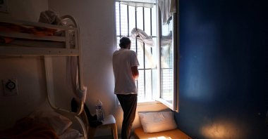 An inmate looks out the window from his prison cell as he tries to stay cool during the heatwave, Orleans, France, July 13, 2026. (Reuters Photo)