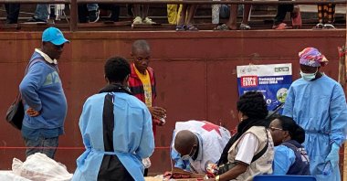 Passengers who disembarked from a boat intercepted by health authorities wait to be tested following the death of a passenger suspected of having Ebola, Kinshasa, DRC, Aug. 6, 2026. (Reuters Photo)