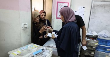 Medics distribute medication to Palestinian patients at a makeshift pharmacy set up by Israeli NGO Physicians for Human Rights-Israel (PHRI)'s mobile clinic in Iktaba, on the outskirts of Tulkarem, West Bank, Aug. 4, 2026. (AFP Photo)