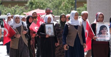 A group of women seeking the return of their children brainwashed to join the PKK carry photos of their children during a protest, Van, eastern Türkiye, July 30, 2026. (AA Photo)