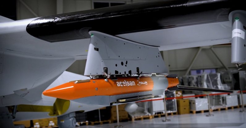 Tolun P precision-guided bunker-busting munition is seen attached to the Bayraktar Akıncı combat drone. (DHA Photo)