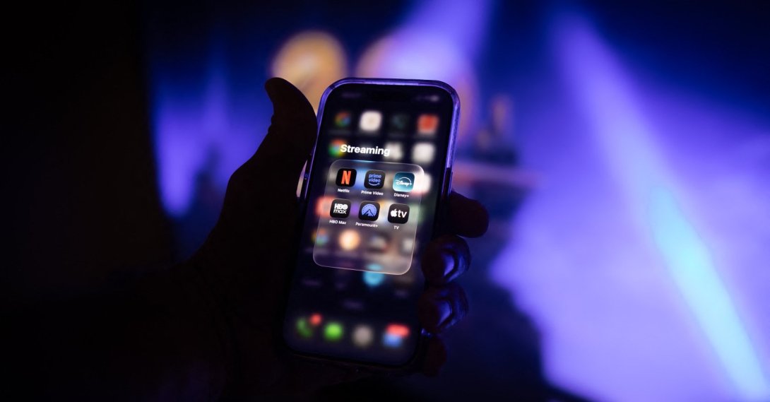 Streaming video services are displayed on a smartphone screen in front of a television in Sartene, South Corsica, France, June 1, 2026. (AFP File Photo)
