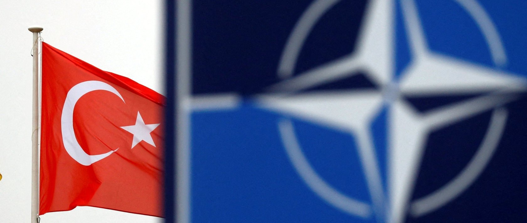 A Turkish flag flies next to the NATO logo at the alliance's headquarters in Brussels, Belgium, Nov. 26, 2019. (Reuters File Photo)