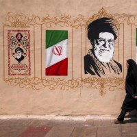 A woman walks past a mural depicting Iran's late supreme leader Ali Khamenei at Valiasr Square, Tehran, Iran, Aug. 8, 2026. (AFP Photo)