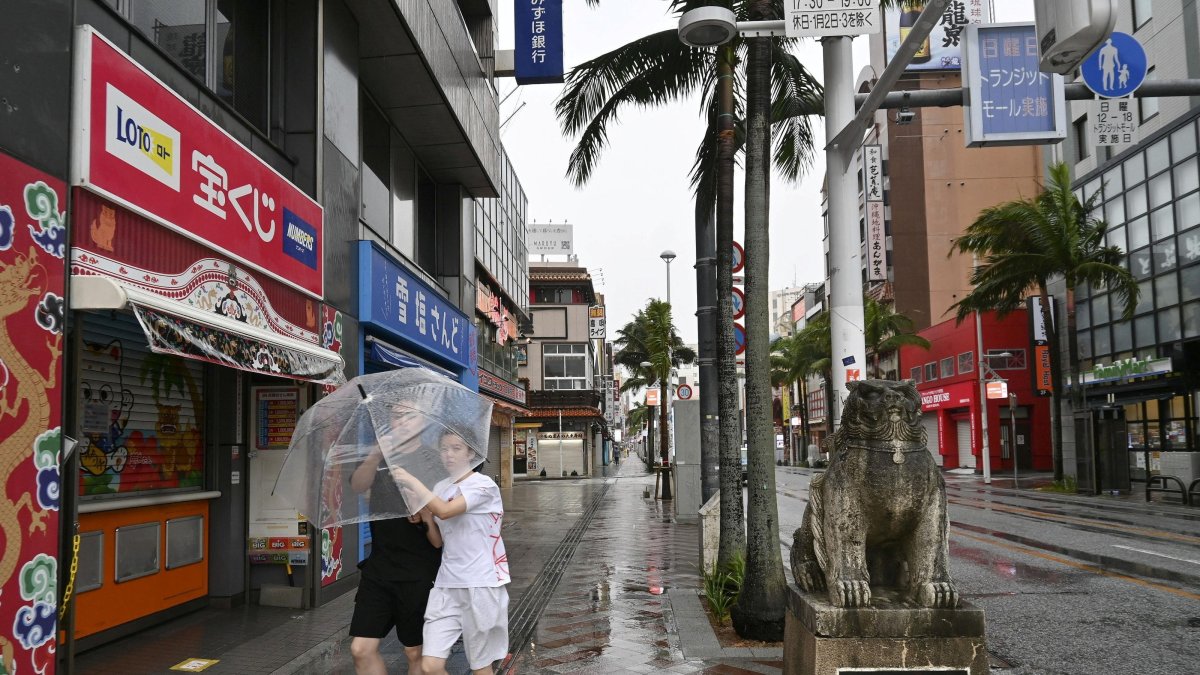 People walk with an umbrella in Naha, Okinawa Prefecture, Japan, Aug. 7, 2026. (Reuters Photo)