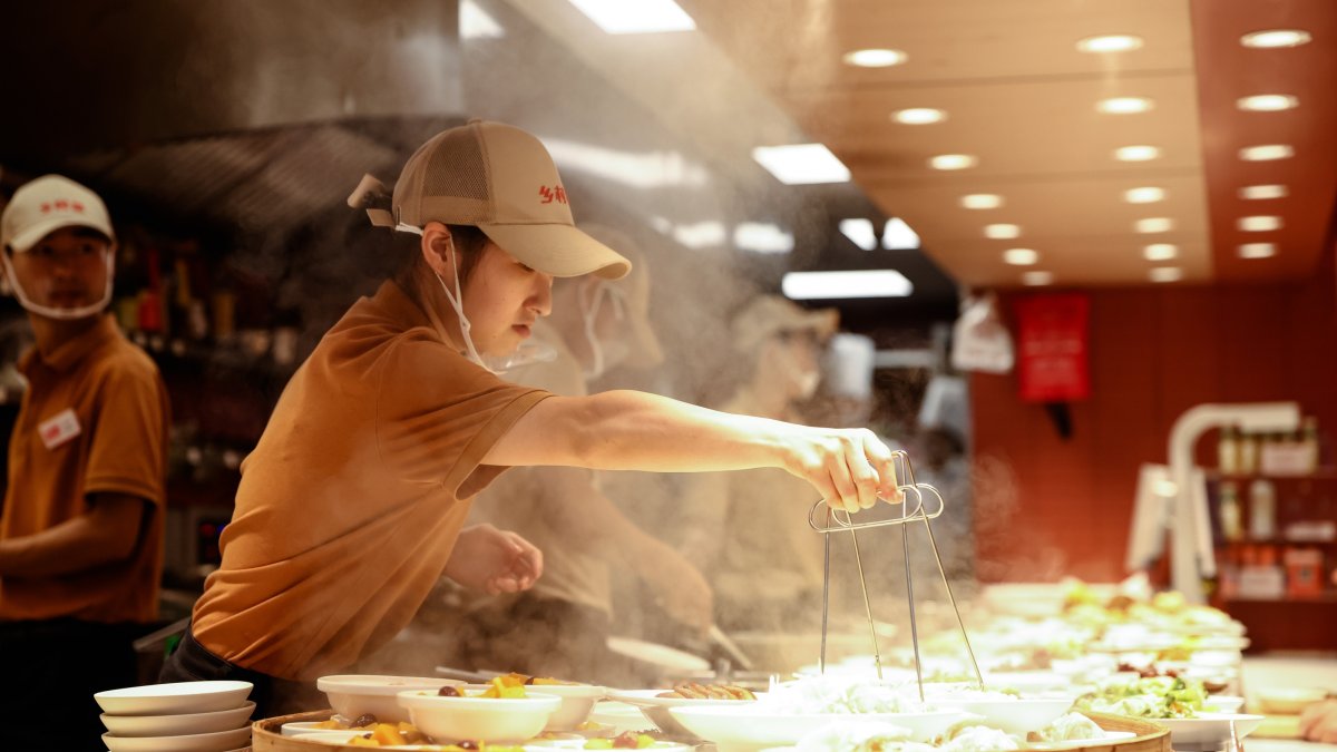 Staff members work in a restaurant, Beijing, China, Aug. 9, 2026. (EPA Photo)