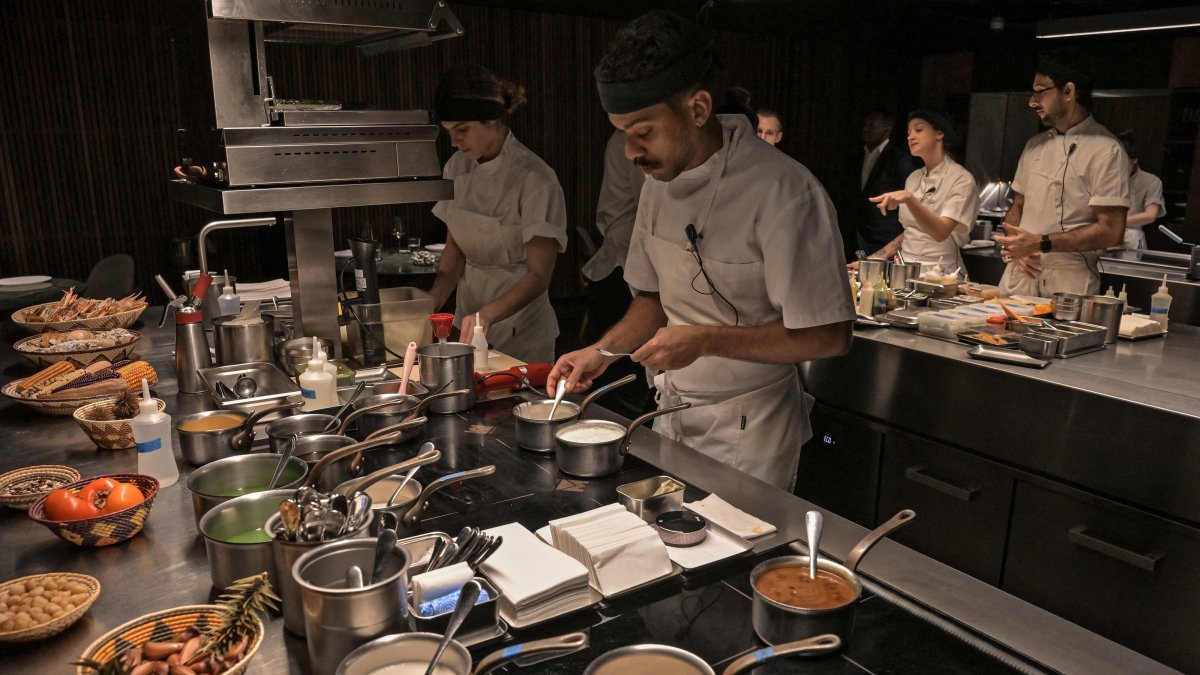 Cooks work in the kitchen of the TUJU restaurant, Sao Paulo, Brazil, July 16, 2026. (AFP Photo)