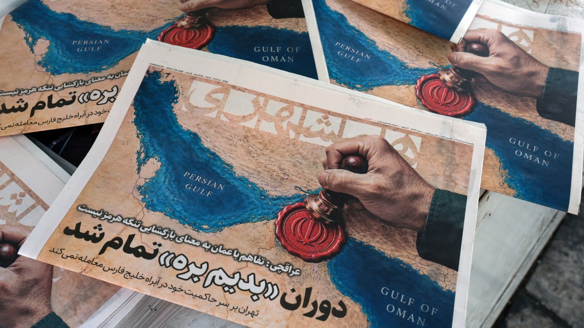 Iranian daily newspaper Hamshahri, featuring a picture of the Strait of Hormuz and a headline quoting Iranian Foreign Minister Abbas Araghchi: 'The Oman deal doesn’t mean the reopening of the Strait of Hormuz,' is seen outside a kiosk in central Tehran, Iran, Aug. 9, 2026. (EPA Photo)