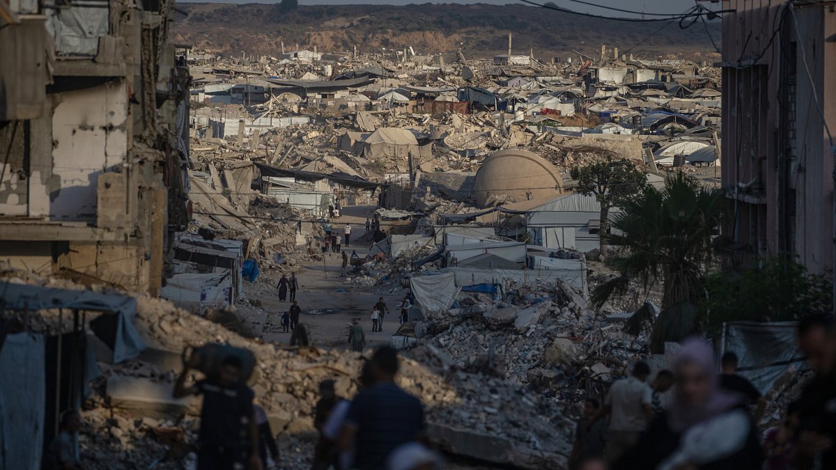 Displaced Palestinians walk amid the rubble of buildings destroyed in Israeli attacks in Jabalya, north of Gaza City, Aug. 7, 2026. (EPA Photo)